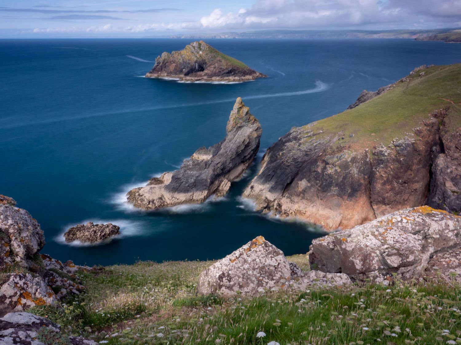View from the Rumps with a trail from a boat on the sea.